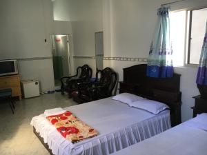 a bedroom with two beds with a slice of pizza at Khách sạn Thiên Phúc in Cà Mau +2 photos