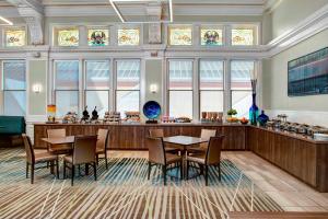 a dining room with tables and chairs and stained glass windows at Residence Inn by Marriott Cleveland Downtown in Cleveland