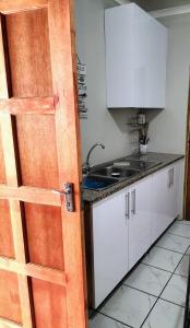 a kitchen with a wooden door in a kitchen at Inkanyezi guest house in Durban