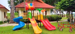 a playground with colorful slides and play equipment at Uthai River Lake Resort in Ban Nong Nam Khan