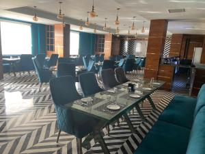 a dining room with a long table and chairs at HOTEL NAT GRAND REGENCY LUDHIANA Punjab INDIA in Ludhiana
