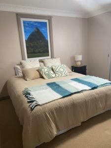 a bedroom with a bed with a view of a mountain at Pomona Noosa Hinterland Homestay in Pomona