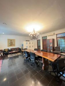 a dining room with a large wooden table and chairs at SOETJIPTO HOME STAY VILLA in Jakarta