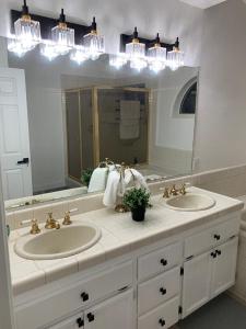 a bathroom with two sinks and a large mirror at Executive home in a serene park like setting in Folsom +43 photos