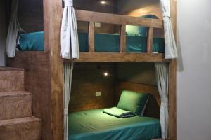 A bed or beds in a room at The Banana Tree Hostel