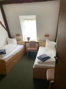 a small room with two beds and a window at Nringrooms Hostel Adenau in Adenau
