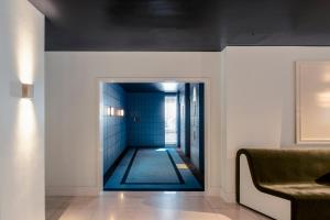 a hallway with a pool in the middle of a room at Amid Hotel Seoul in Seoul