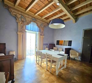 a dining room with a white table and chairs at B&B Dimora Delle Donnole Bergamo Alta in Bergamo