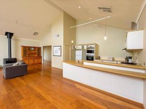 an empty living room with a counter and a kitchen at Sky Blue Retreat in North Boyanup