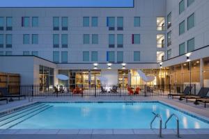 a swimming pool in front of a hotel at Aloft Oklahoma City Quail Springs in Oklahoma City