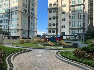 a playground in a park with tall buildings at Pandora's Nest in Manila