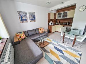 - un salon avec un canapé et une table dans l'établissement Sunny Apartment C25, à Borovets
