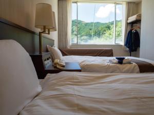 Uma cama ou camas num quarto em 真田昌幸-幸村父子の隠れ宿 紀伊見荘