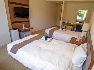 Uma cama ou camas num quarto em 真田昌幸-幸村父子の隠れ宿 紀伊見荘