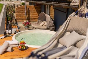 a hot tub sitting on a deck with a bowl of fruit at Meerberg in Pertisau