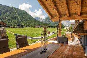 a view from the porch of a house with a hammock at Meerberg in Pertisau