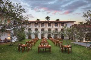 a courtyard with tables and chairs in front of a building at Heritance Ayurveda - All Meals and Treatments in Bentota