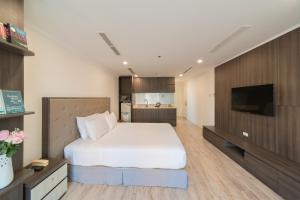 a bedroom with a bed and a flat screen tv at Seven Seas Hotel Nha Trang in Nha Trang