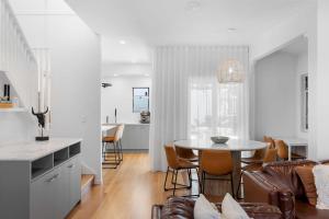 a kitchen and living room with a table and chairs at La Mer in Marcoola in Marcoola