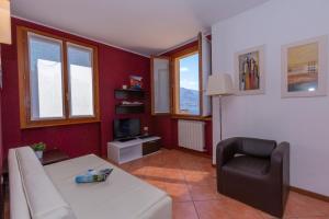 a living room with a couch and a chair at Fontana Del Lago Apartments in Varenna