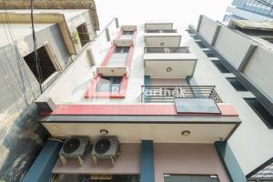 a view of the side of a building with balconies at Star Hotel Jaksa Mitra RedDoorz in Jakarta