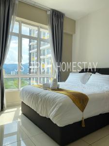 a bedroom with a large bed and a large window at JS Ipoh Homestay @ The Majestic Ipoh in Ipoh