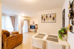 a living room with a table and a couch at Luxury 2 bedroom Condo Old city in Chiang Mai