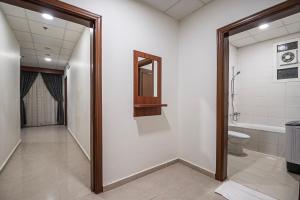 a bathroom with a toilet and a bath tub at فندق غالية احد in Al Madinah