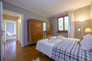 a bedroom with a bed with a checkered blanket at Villa Paola Tremezzo in Tremezzo