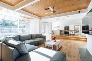 a living room with a couch and a table at 'Poolside Haven' Your Mount Eliza Family Getaway in Melbourne