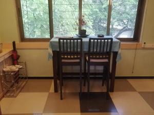 a dining room table with two chairs and a blue table cloth at NeXstage Terraces, The Blue Lagoon Suite, Carter Road, Bandra West in Mumbai