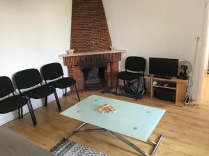 a living room with a fireplace and a table and chairs at Petite villa le clan in Ajaccio