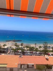 a view of a beach and the ocean from a building at Apartamentos Vista Bahia in Los Cristianos