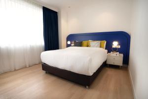 Postel nebo postele na pokoji v ubytování Ukiyo Suites