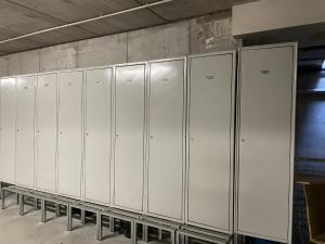 a row of white lockers in a room at 058 Trilocale Baldino, Pinzolo in Pinzolo