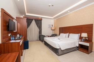 a hotel room with a bed and a television at فندق غالية احد in Al Madinah