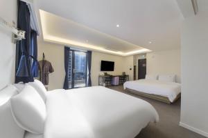 Postel nebo postele na pokoji v ubytování Bonatree Hotel + 71 fotografií