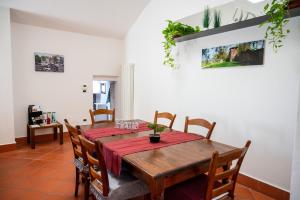 a dining room with a wooden table and chairs at Ferrara center - Luxury apartment in medieval area with Wi-Fi in Ferrara