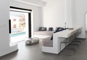 a white room with a bed and a table and chairs at Shape-Infinity in Kalymnos