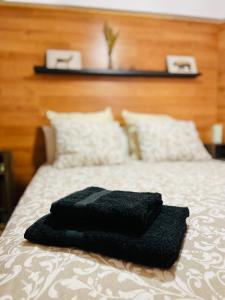 a black towel sitting on top of a bed at Nuevo Cosy Loft 4pax Estavar in Estavar