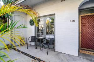 a patio with chairs and a table in front of a house at The Young - A Peaceful Parkside Delight in Sydney