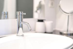 a sink with a faucet in a bathroom at Apartment FERIA 2 in Opatija +51 photos