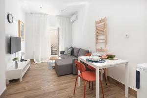 a living room with a couch and a table with chairs at Apartment FERIA 2 in Opatija