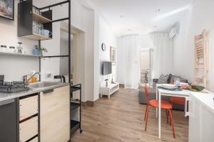 a kitchen and living room with a table and chairs at Apartment FERIA 2 in Opatija