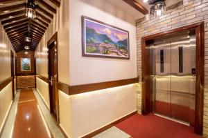 a hallway of a building with a painting on the wall at Airport Himalaya Boutique Hotel in Kathmandu