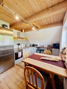 a kitchen with a table and chairs in a room at Wood & Stone Lodge 2 in Donaueschingen
