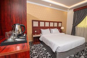 a hotel room with a bed and a table with a coffee maker at فندق غالية احد in Al Madinah