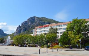 a hotel with a mountain in the background at Hemus Hotel - Vratza in Vratsa