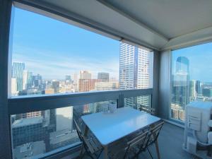 a balcony with a table and a view of the city at The Escape in Southern Cross Station in Melbourne