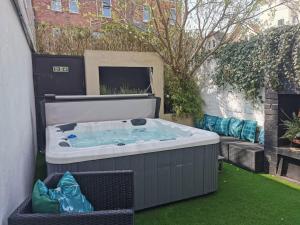 a hot tub in the backyard of a house at Bournemouth Beach Boutique with Hot Tub in Bournemouth